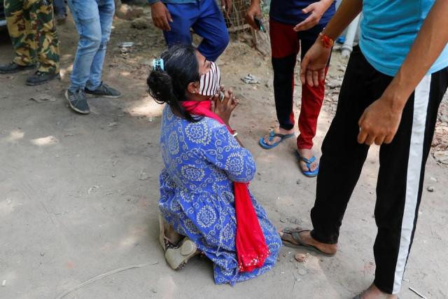 shruti saha who had been waiting since tuesday night for her turn to get an oxygen cylinder refilled for her mother reacts after she was informed about her mother s death outside a refilling workshop in new delhi india april 28 2021 photo reuters shruti saha who had been waiting since tuesday night for her turn to get an oxygen cylinder refilled for her mother reacts after she was informed about her mother s death outside a refilling workshop in new delhi india april 28 2021 photo reuters