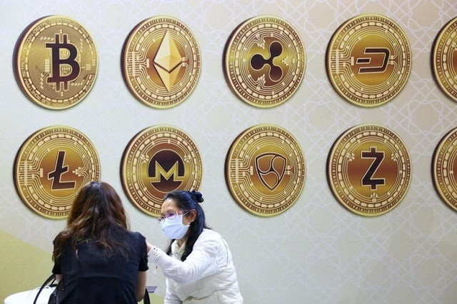 customers talk against a backboard with signs of cryptocurrency during 2020 taipei international finance expo in taipei taiwan november 27 2020 photo reuters customers talk against a backboard with signs of cryptocurrency during 2020 taipei international finance expo in taipei taiwan november 27 2020 photo reuters