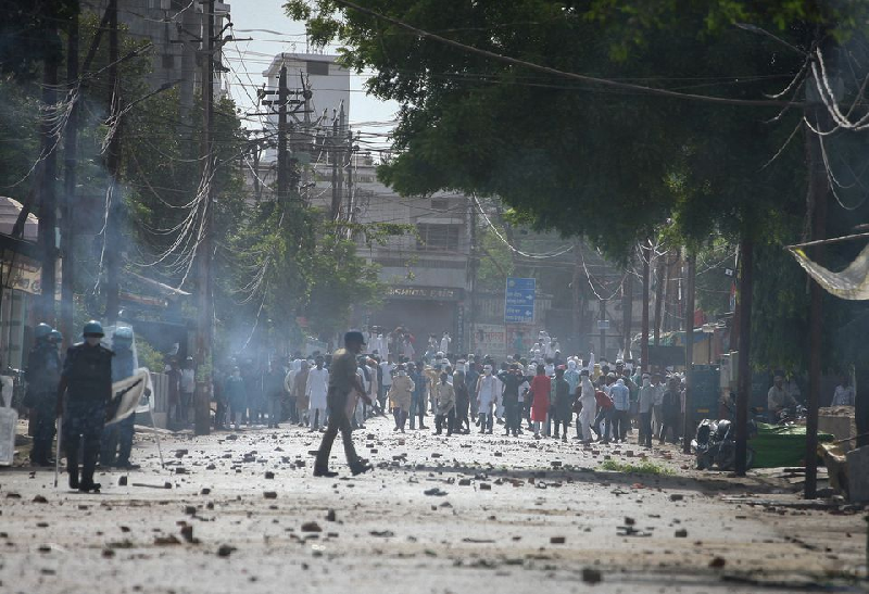 Protestors throw stones towards police during a protest demanding the arrest of BJP member Nupur Sharma in Prayagraj, India, June 10, 2022. PHOTO: REUTERS