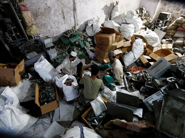 men recycle electronic waste or e waste from computers at a workshop in new delhi india july 29 2020 photo reuters