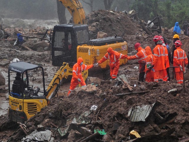 rescue workers look for survivors at the site of a landslide during heavy rains in idukki kerala india august 9 2020 photo reuters