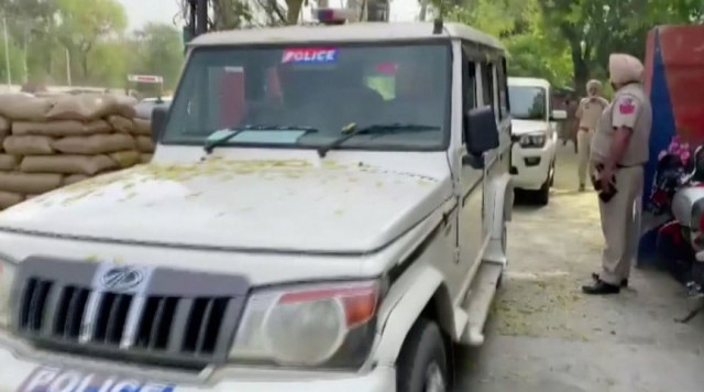 police vehicles leave a police station following a firing incident at a military station that killed four people in bhatinda punjab india april 12 2023 in this screengrab taken from a handout video ani handout via reuters