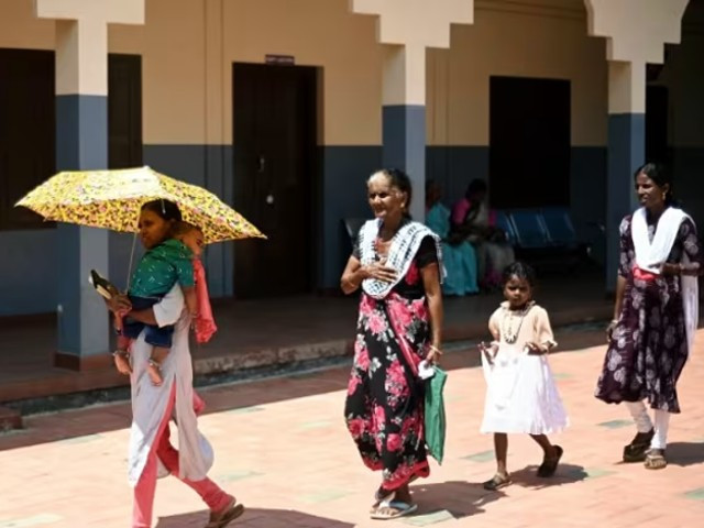 people carry umbrellas as they arrive to cast their vote at a polling station during the second phase of voting of india s general election in wayanad district in kerala on apr 26 2024 photo afp people carry umbrellas as they arrive to cast their vote at a polling station during the second phase of voting of india s general election in wayanad district in kerala on apr 26 2024 photo afp