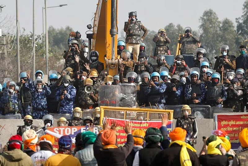 farmers gesture towards police at a protest site as they march towards new delhi at shambhu barrier india february 21 2024 photo reuters