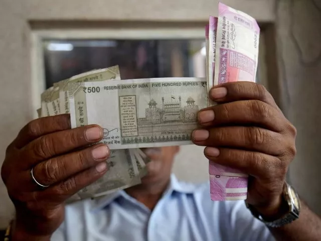 a cashier checks indian rupee notes inside a room at a fuel station in ahmedabad india photo reuters a cashier checks indian rupee notes inside a room at a fuel station in ahmedabad india photo reuters