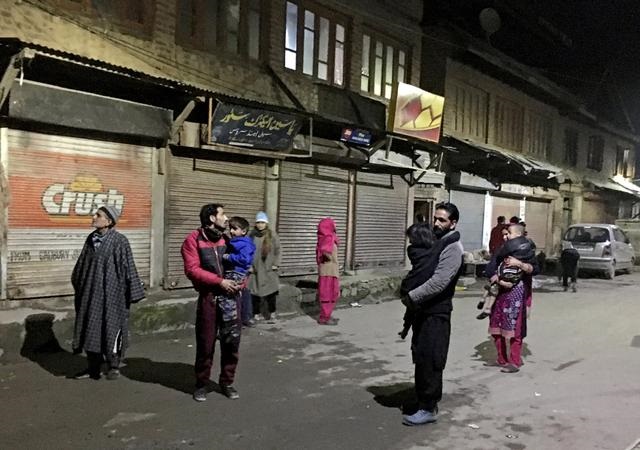 residents carrying their children stand on a road after vacating their houses following an earthquake in srinagar february 12 2021 photo reuters