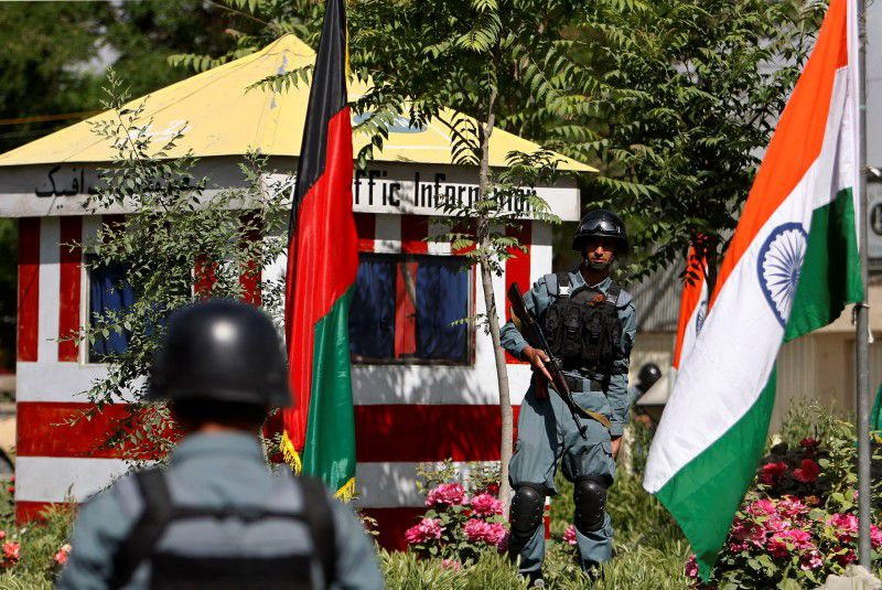 afghan policemen stand guard next to indian and afghan national flags at a check point in kabul city may 12 2011 photo reuters