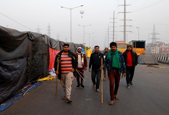 farmers holding sticks patrol at the site of a protest against farm laws at ghaziabad india january 28 2021 photo reuters