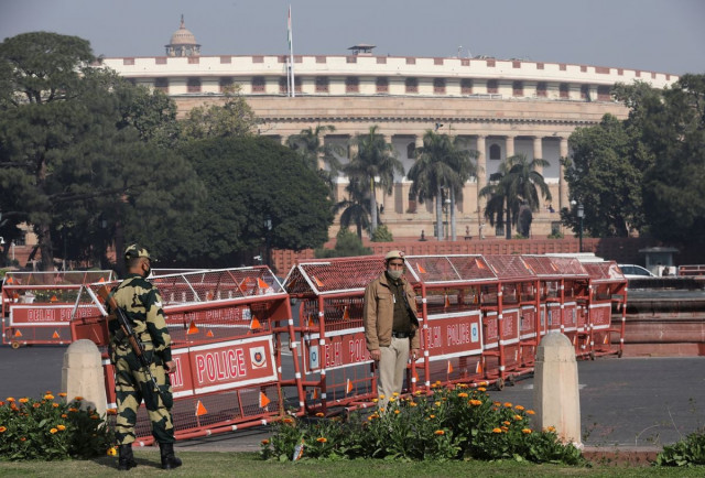 security personnel stand guard next to barricades outside the parliament where annual budget is being presented in new delhi india february 1 2021 reuters anushree fadnavis security personnel stand guard next to barricades outside the parliament where annual budget is being presented in new delhi india february 1 2021 reuters anushree fadnavis