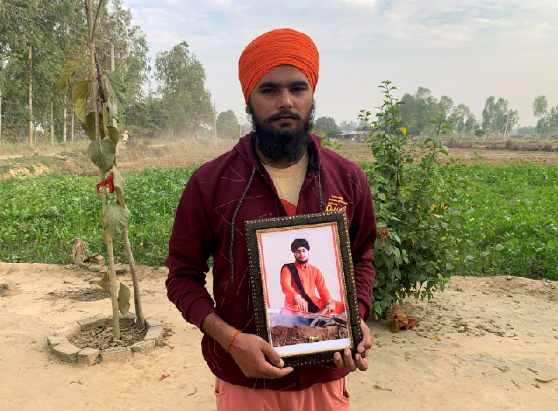 guru sevak singh a farmer poses with a photograph of his brother guruvinder singh who was killed during a farmers protest in lakhimpur kheri last month in mohraniya village of the bahraich district in the northern state of uttar pradesh india november 19 2021 photo reuters