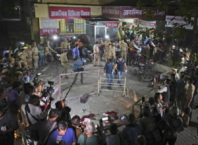 lice and media surround the area where former mp atiq ahmad and his brother ashraf were shot in uttar pradesh india saturday april 15 2023 photo ap lice and media surround the area where former mp atiq ahmad and his brother ashraf were shot in uttar pradesh india saturday april 15 2023 photo ap