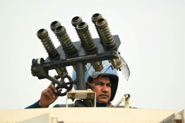 an indian security officer stands atop an armoured vehicle at a roadblock during protests called by farmers on tuesday photo afp an indian security officer stands atop an armoured vehicle at a roadblock during protests called by farmers on tuesday photo afp
