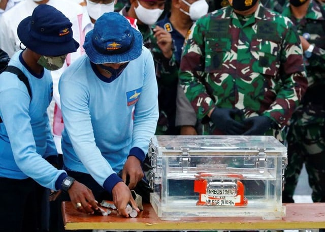 indonesia navy members carry a part of the retrieved black box of sriwijaya air flight sj 182 which crashed into the sea at the weekend off the jakarta coast in jakarta indonesia january 12 2021 photo reuters