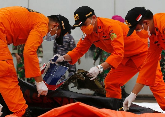 indonesian rescue members inspect what is believed to be the remains of the sriwijaya air plane flight sj182 which crashed into the sea at jakarta international container terminal port in jakarta indonesia january 10 2021 photo reuters
