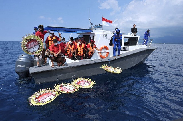 people throw flowers and petals with names of the sunken kri nanggala 402 submarine crew members from the boat during a prayer at the sea near labuhan lalang bali indonesia april 26 2021 photo reuters