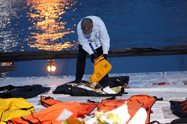 national transportation safety commission knkt officer inspects the debris of sriwijaya air flight sj 182 which crashed to the sea at tanjung priok port in jakarta indonesia january 13 2021 photo reuters