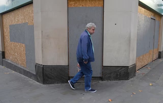 a man walks past a boarded up retail premises in london britain reuters file photo