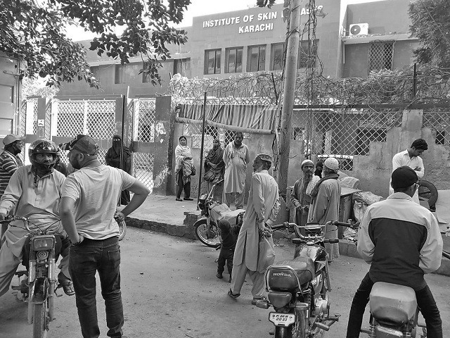 people stand outside the institute of skin diseases which has been shut down by protesting doctors photo express