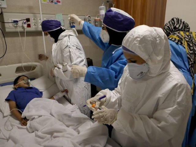 Nurses take samples from an infected child to test for the coronavirus disease (Covid-19), at a hospital in Tehran, Iran. PHOTO: REUTERS/FILE