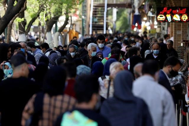 iranians wearing protective face masks against the coronavirus walk in a crowded area of the capital tehran iran march 30 2021 photo reuters