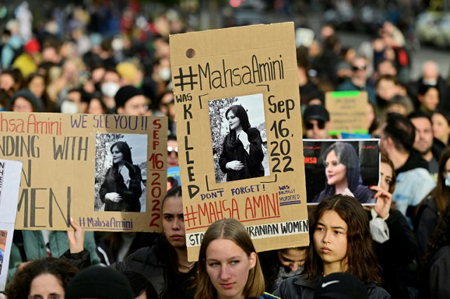 demonstrators in berlin hold up placards with images of mahsa amini in berlin photo afp