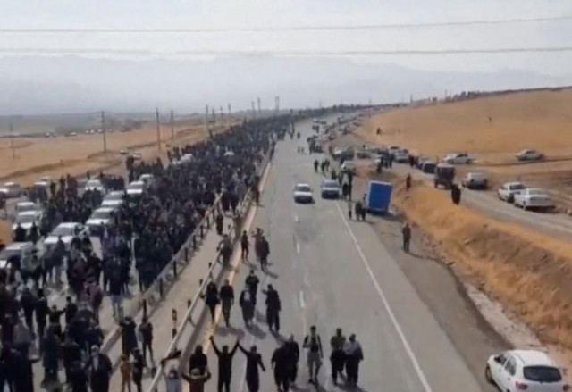 people march down the highway toward the aychi cemetery where mahsa amini is buried near saqez iran in this screengrab taken from a social media video released october 26 2022 and obtained by reuters people march down the highway toward the aychi cemetery where mahsa amini is buried near saqez iran in this screengrab taken from a social media video released october 26 2022 and obtained by reuters