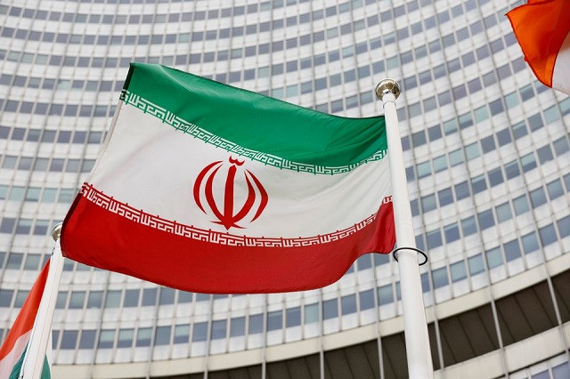 the iranian flag waves in front of the international atomic energy agency iaea headquarters in vienna austria may 23 2021 photo reuters