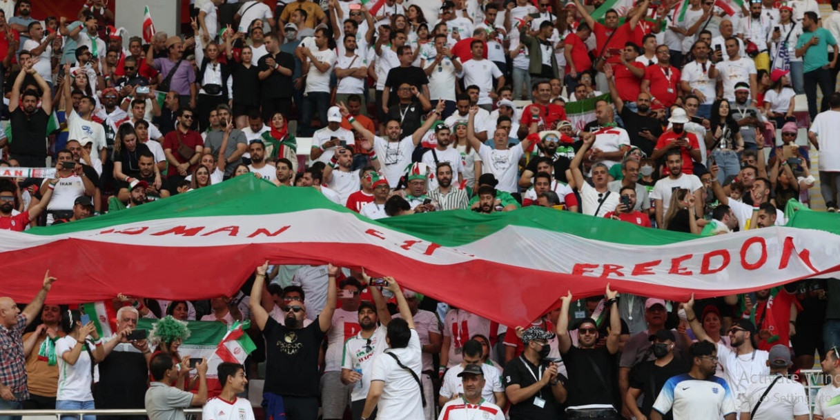 iran supporters wave their national flag emblazoned with the slogan woman life freedom during the qatar 2022 world cup match against in doha on november 21 2022 fadel senna afp