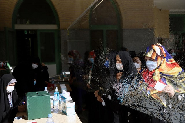 Iranians wait to vote at a polling station during presidential elections in Tehran, Iran June 18, 2021. PHOTO: REUTERS