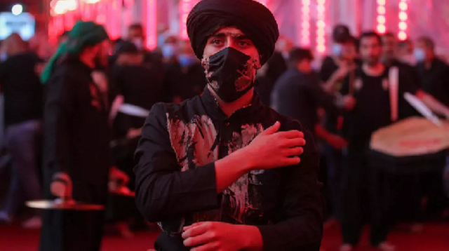 a shia muslim commemorates the martyrdom of the imam hussain ra at his shrine in the iraqi city of karbala photo afp