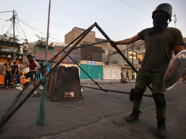 iraqi protesters gather at a roadblock in al tayaran square in central baghdad on july 28 2020 during ongoing anti government protest due to poor public services photo afp file