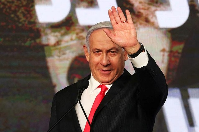 israeli prime minister benjamin netanyahu gestures as he delivers a speech to supporters following the announcement of exit polls in israel s general election at his likud party headquarters in jerusalem march 24 2021 photo reuters