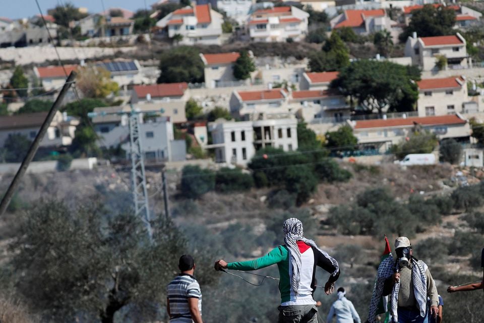 palestinian demonstrators stand in front of a jewish settlement during a protest in kafr qaddum in the israeli occupied west bank november 13 2020 reuters mohamad torokman file photo