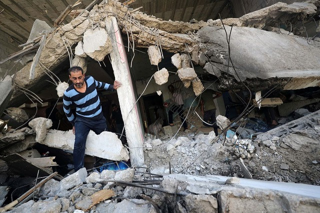 a palestinian man walks through the ruins in the aftermath of israeli air strikes in gaza city may 17 2021 photo reuters