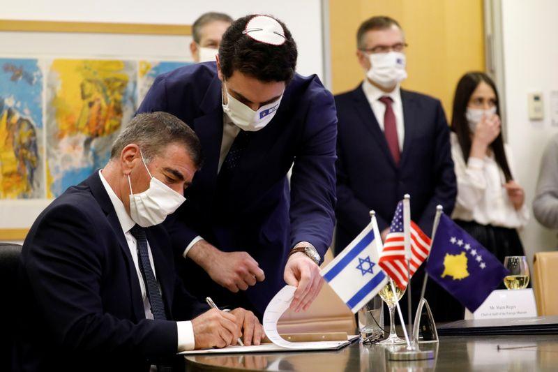 israel s foreign minister gabi ashkenazi signs the agreement establishing diplomatic relations between israel and kosovo during a virtual ceremony with kosovo s foreign minister meliza haradinaj stublla in the israeli foreign ministry in jerusalem february 1 2021 photo reuters