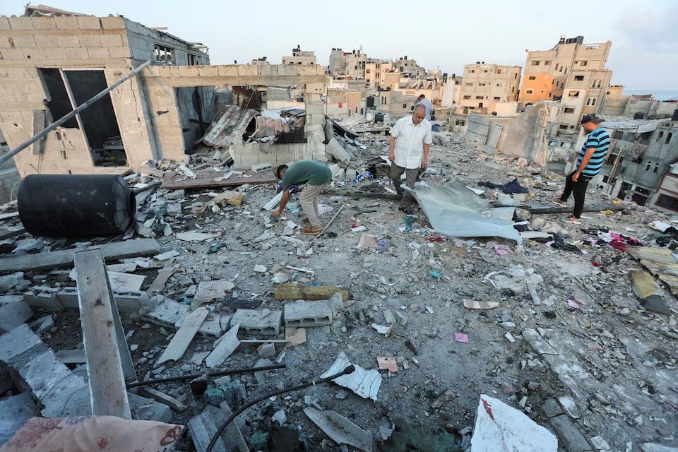 palestinians inspect the site of an israeli strike on a house in deir al balah in the central gaza strip on august 4 2024 photo reuters