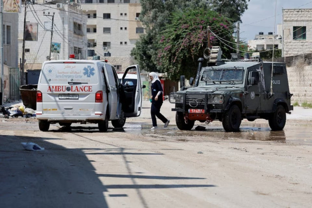 a woman walks during an israeli raid in jenin in the israeli occupied west bank on august 30 2024 photo reuters a woman walks during an israeli raid in jenin in the israeli occupied west bank on august 30 2024 photo reuters
