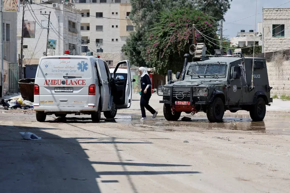 a woman walks during an israeli raid in jenin in the israeli occupied west bank on august 30 2024 photo reuters a woman walks during an israeli raid in jenin in the israeli occupied west bank on august 30 2024 photo reuters