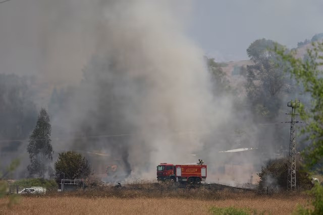 firefighters respond to a fire near a rocket attack from lebanon near kiryat shmona northern israel june 14 2024 photo reuters