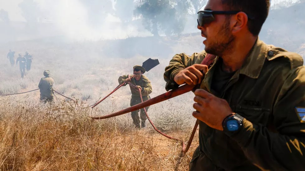 fire bombs fitted to balloons launched across the border from gaza have sparked extensive blazes on farmland in southern israel photo afp