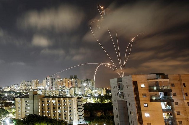 streaks of light are seen as israel s iron dome anti missile system intercepts rockets launched from the gaza strip towards israel as seen from ashkelon israel may 12 2021 photo reuters