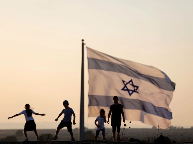 israeli kids play next to an israeli flag next to the israeli syrian border at the israeli occupied golan heights israel photo reuters ronen zvulun file photo