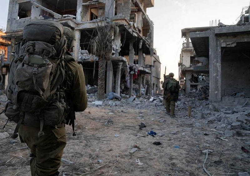Israeli soldiers take part in ground operations in a location referred to as Gaza in this handout photo released November 7, 2023. PHOTO: REUTERS