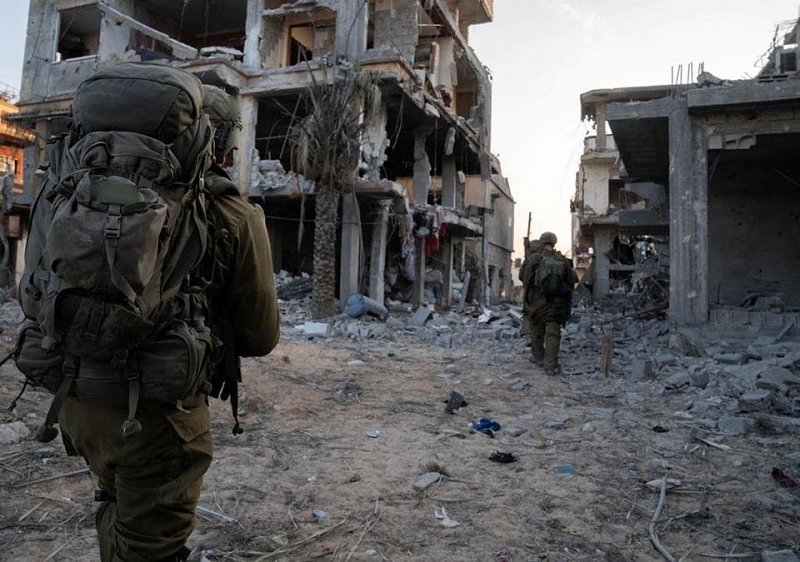 Israeli soldiers take part in ground operations at a location given as Gaza in this handout photo released November 7, 2023. PHOTO: REUTERS