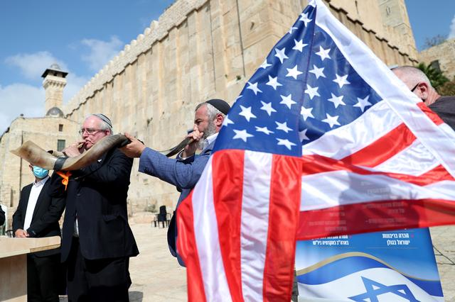 israeli settlers blow the shofar a ceremonial ram s horn as they gather to show their support for president trump in the upcoming us election at the cave of the patriarchs in the palestinian city of hebron photo reuters