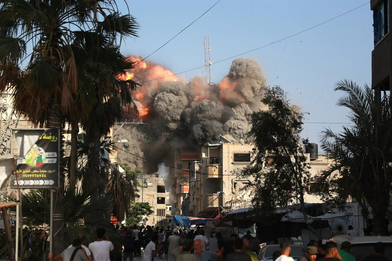 A ball of fire and black smoke after an Israeli air strike targeted a residential building in Bureij in central Gaza. PHOTO: AFP