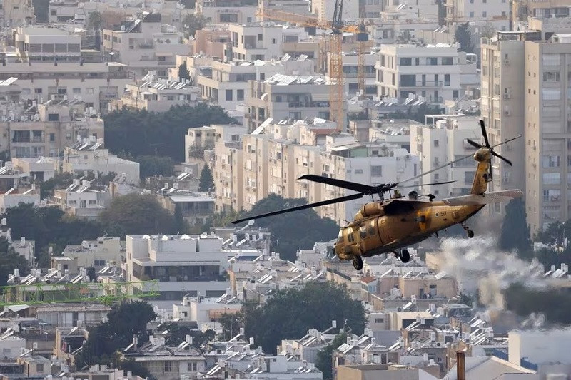 A military helicopter flies over Tel Aviv after lifting off from the Tel Aviv Sourasky Medical Center (Ichilov), Israel, December 27, 2023. PHOTO: REUTERS