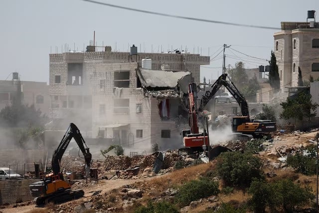 israeli machinery guarded by israeli forces demolishes a palestinian house near hebron in the israeli occupied west bank july 11 2024 photo reuters