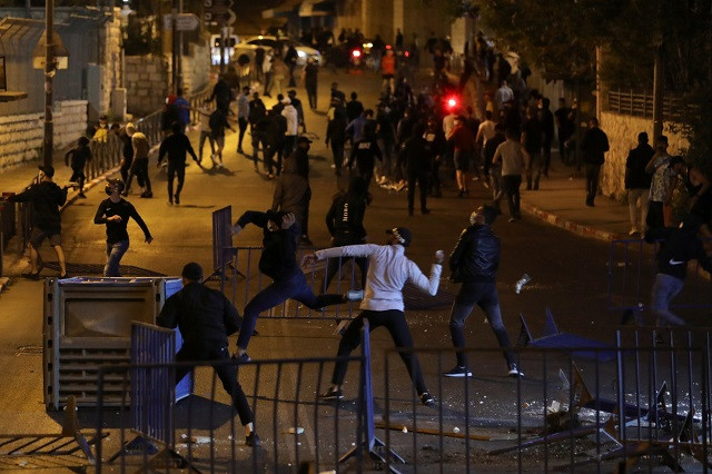 palestinian protesters throw objects during clashes with israeli police as the muslim holy fasting month of ramadan continues in jerusalem april 23 2021 photo reuters