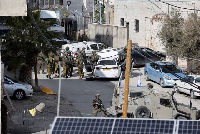 israeli troops stand guard near a shooting scene in hebron in the israeli occupied west bank february 1 2024 photo reuters israeli troops stand guard near a shooting scene in hebron in the israeli occupied west bank february 1 2024 photo reuters